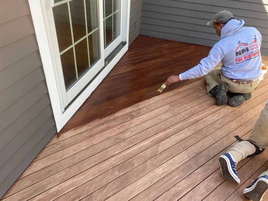 Crew member staining a new deck