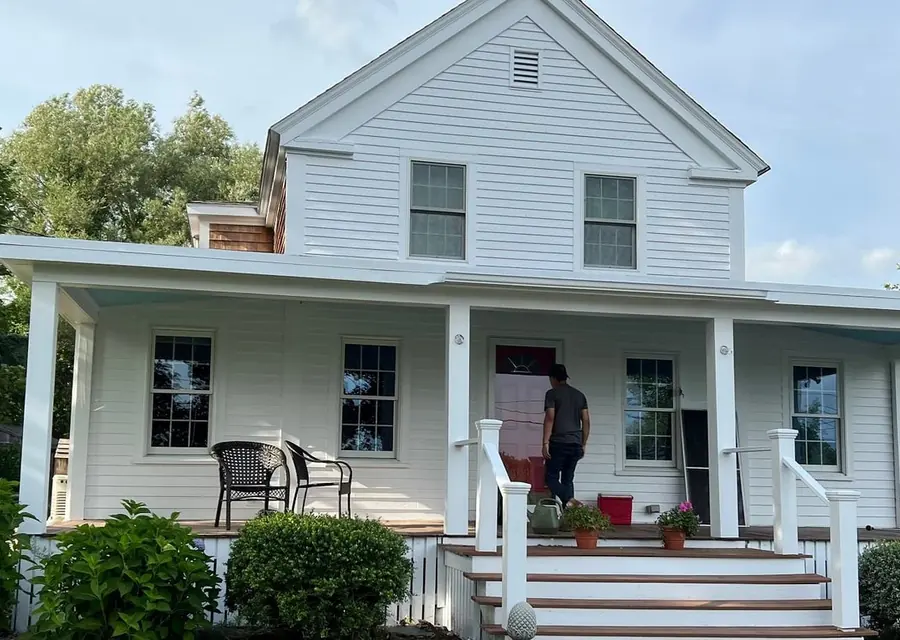 White farmhouse with a freshly painted front porch