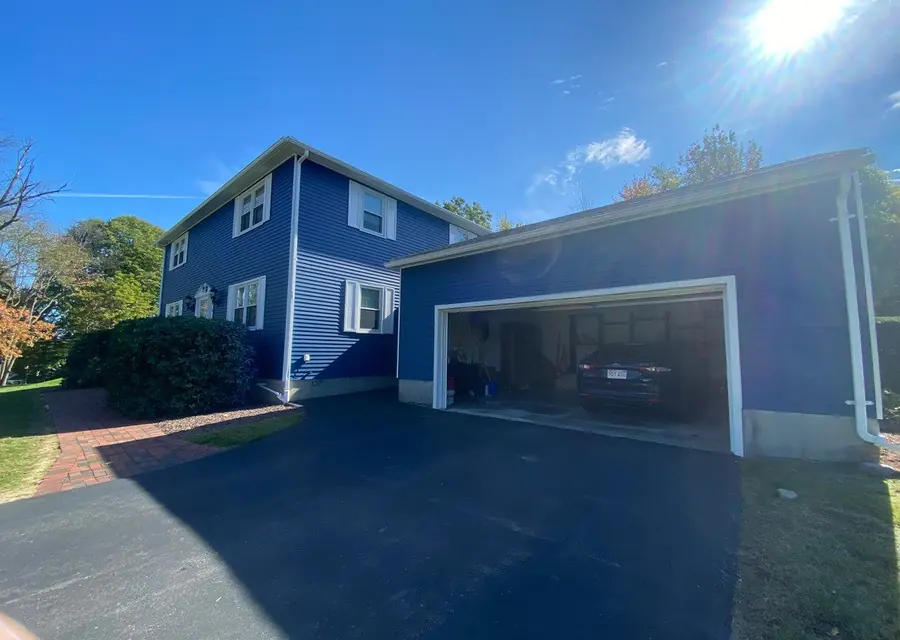Two-story home in Peabody freshly painted blue with white trim