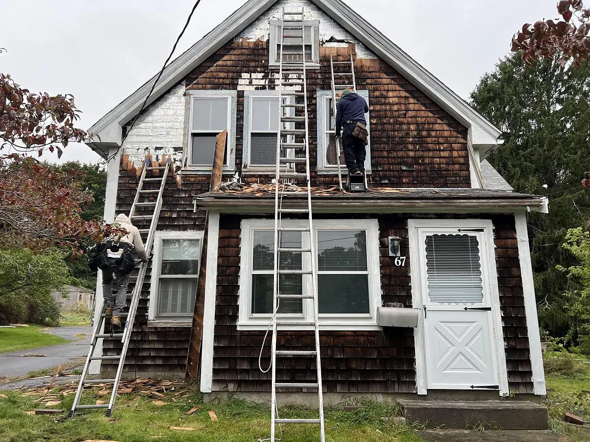 Before: cape with old dark shingles repainted light blue