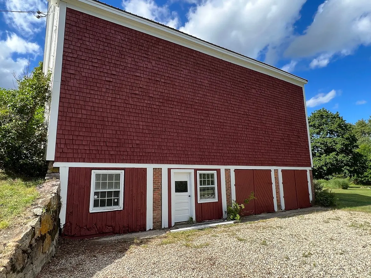 After: red barn with peeling paint restored