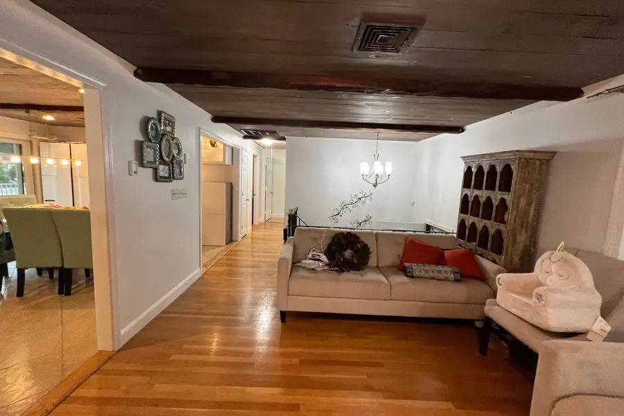 Living room with freshly painted white walls and hardwood floors