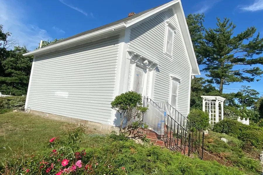 Freshly painted white house exterior with black shutters
