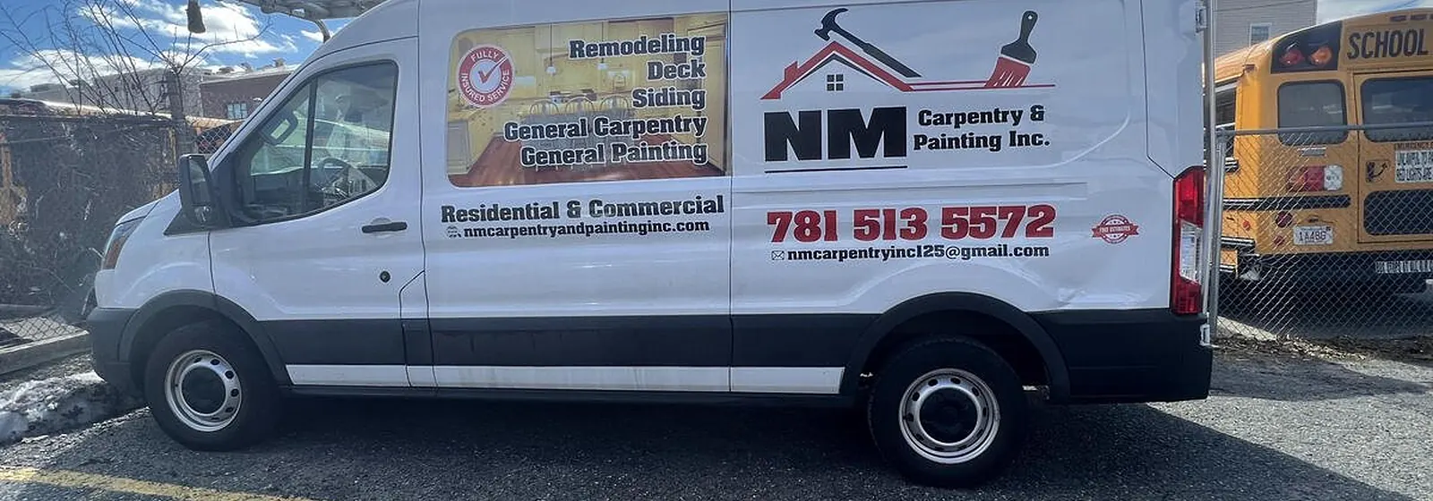NM Carpentry and Painting van parked at a job