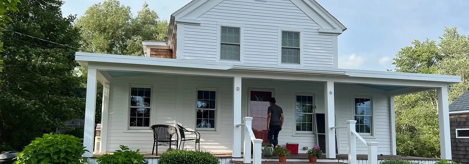 White farmhouse with a freshly painted front porch