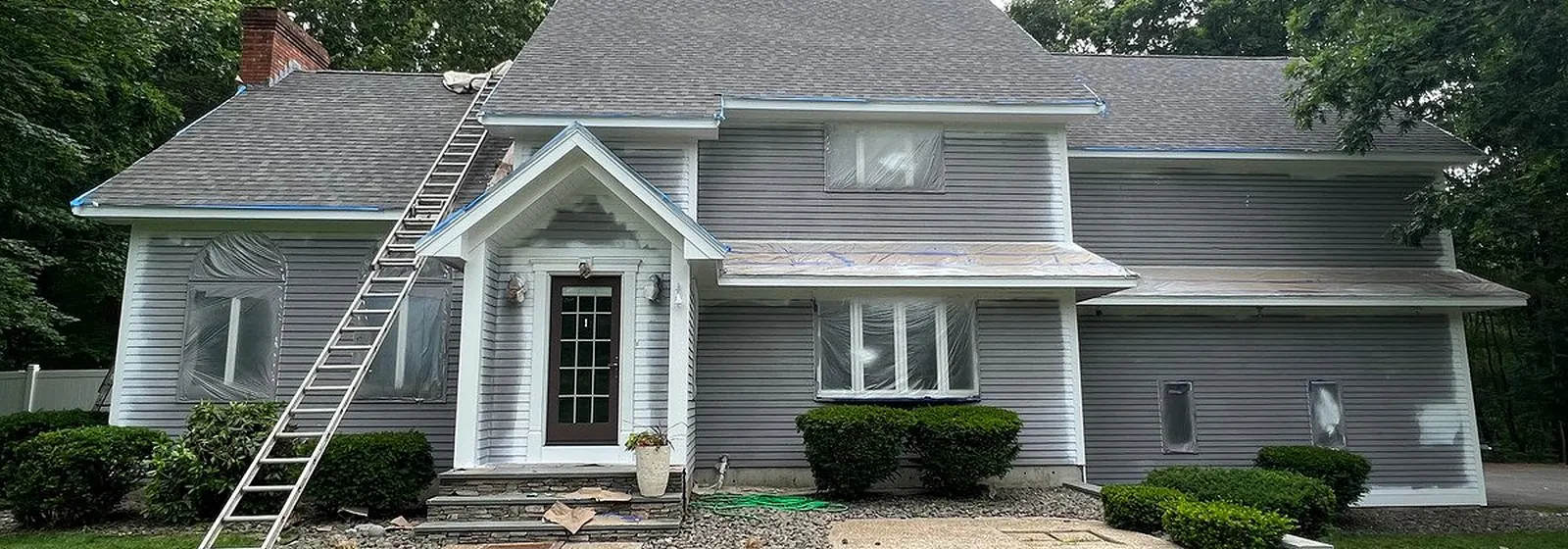 Colonial home with fresh gray siding and white trim