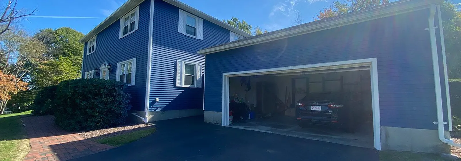 Two-story home in Peabody freshly painted blue with white trim