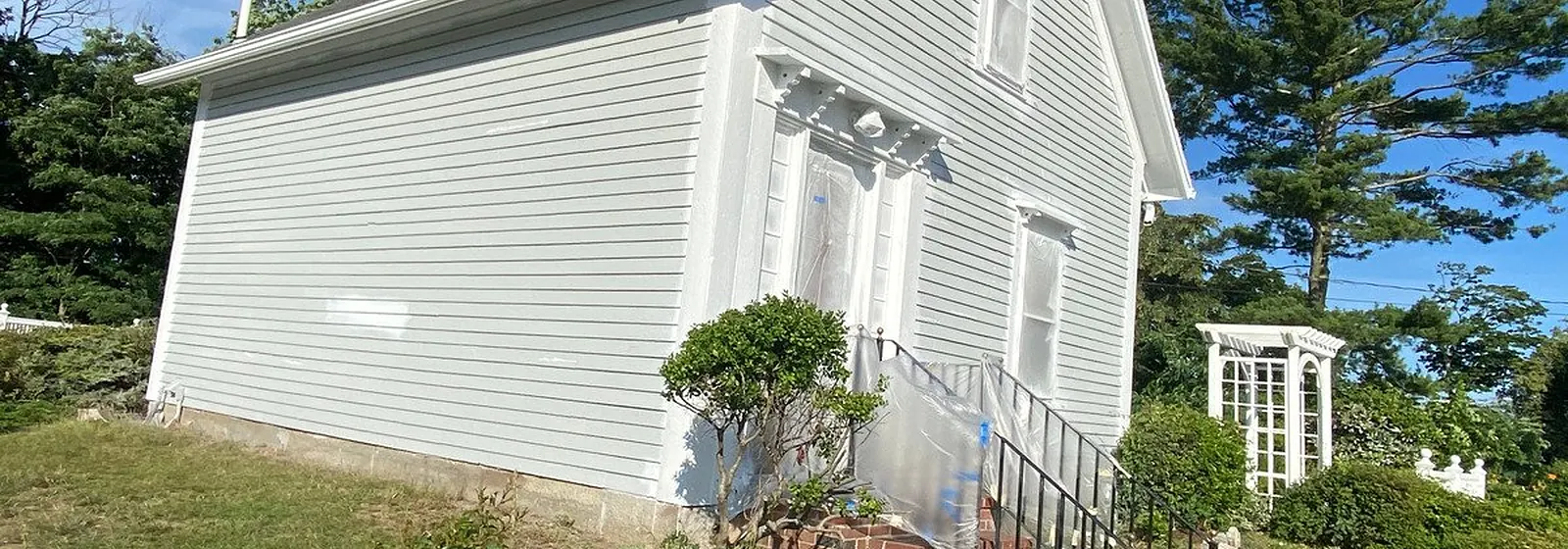 White clapboard home after painting