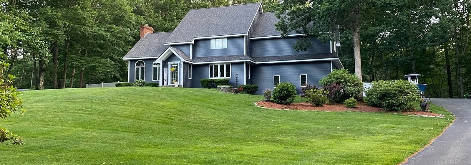 Dark gray home with white trim after exterior painting