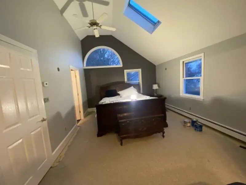 Freshly painted bedroom with a vaulted ceiling and skylight
