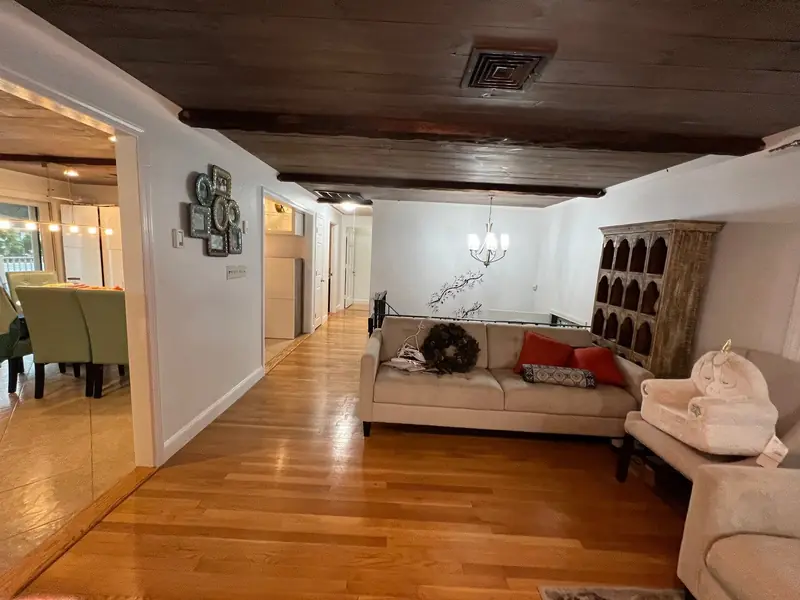 Living room with freshly painted white walls and hardwood floors