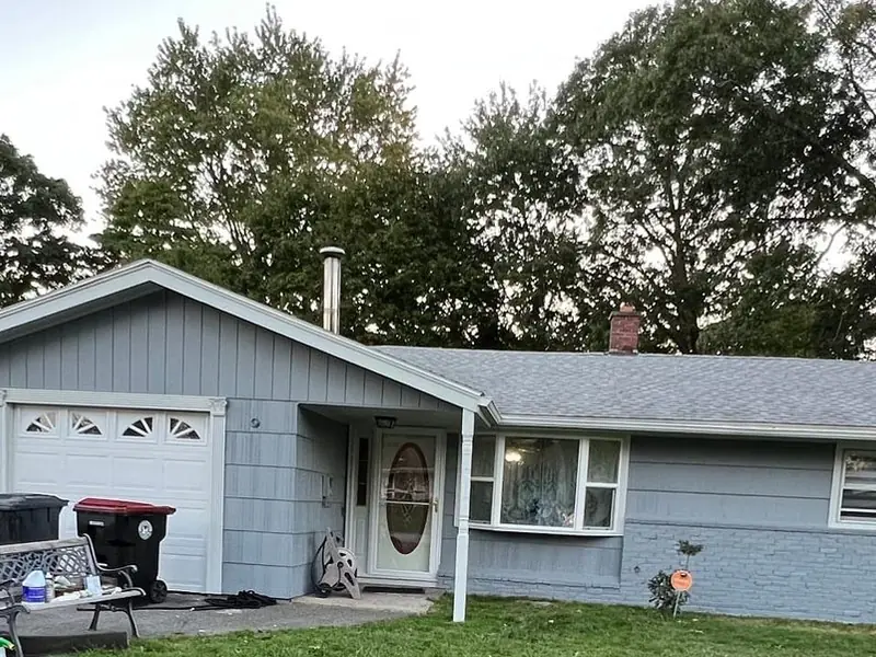 Gray ranch home with white trim and a garage