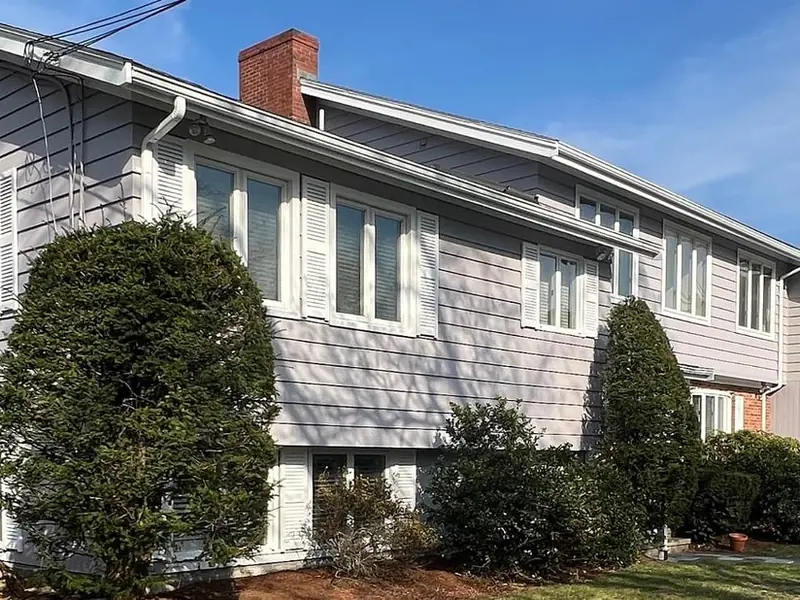 Two-story home with fresh gray siding and white trim