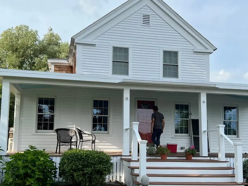 White farmhouse with a freshly painted front porch