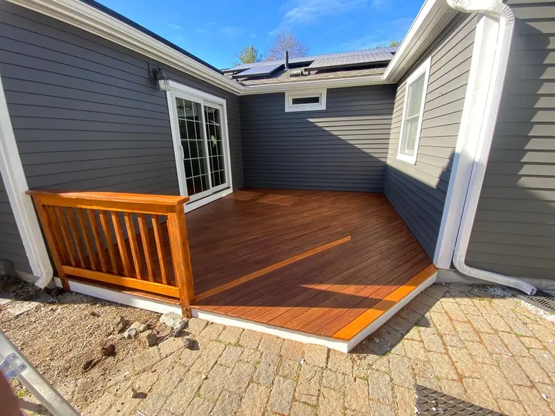 Stained deck attached to a dark gray home