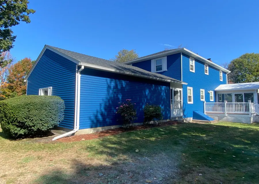 Two-story home freshly painted light blue with white trim