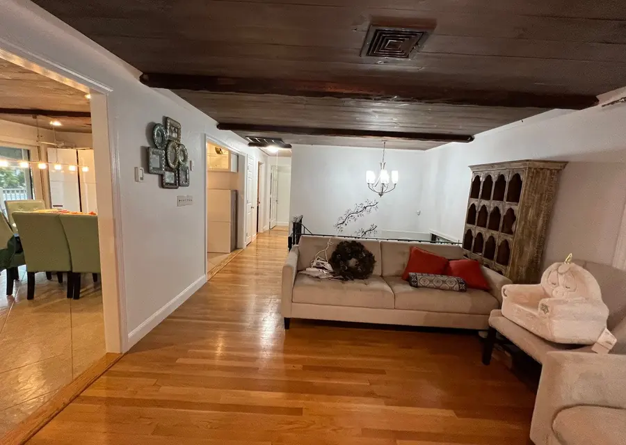 Living room with freshly painted white walls and a wood ceiling